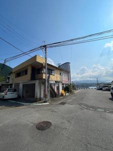 a street with a building on the side of the road at 一棟貸切ゲストハウス in Enoura