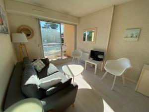 a living room with a couch and chairs and a television at C219 -2 pieces avec parking proche plage in Arcachon