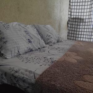 a bed with white sheets and pillows on it at BeVibe in Malabe