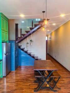 a room with a staircase with a wooden table and a dining room at Premium Vintage Home 2 Master Bedrooms 2 to 4 Pax Comfy Stay for Friends and Family in Cyberjaya
