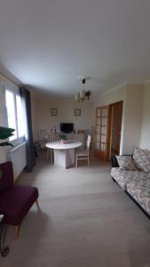 a living room with a couch and a table at Appartement de maison avec 2 chambres in Ossun