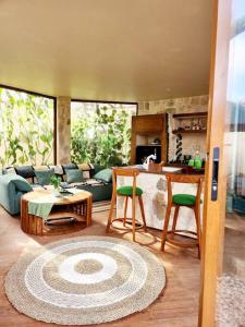 a living room with a couch and a table at Jungle Circle Uluwatu in Uluwatu