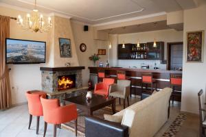 a living room with a bar and a fireplace at Hotel Agnanti Unique Hospitality in Kastoria
