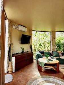 a living room with a couch and a table at Jungle Circle Uluwatu in Uluwatu