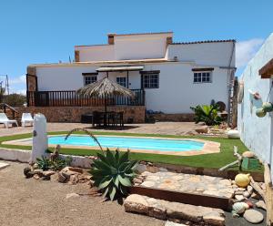 a house with a swimming pool in front of a house at Casa Elsa in Puerto del Rosario
