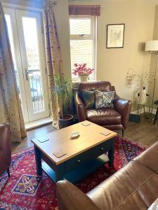 a living room with a couch and a coffee table at Luxurious two-bedroom apartment in the centre of Peterborough in Peterborough