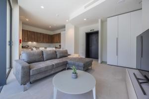 a living room with a couch and a table at Exquisite Residence in Mercury Towers in St. Julianʼs