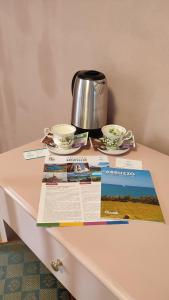 a table with a tea pot and two cups on it at B&B Popoli Terme in Popoli +44 photos