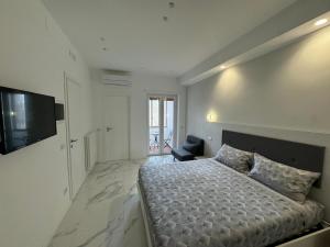 a white bedroom with a bed and a chair at Alba White in Rome