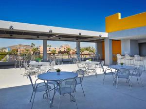 a group of tables and chairs on a patio at Graduate by Hilton Tempe in Tempe