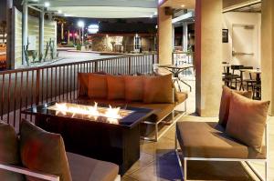 a restaurant with couches and a table and a bar at Graduate by Hilton Tempe in Tempe