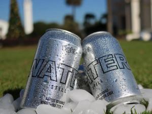two silver cans of water sitting on a pile of rocks at Graduate by Hilton Tempe in Tempe