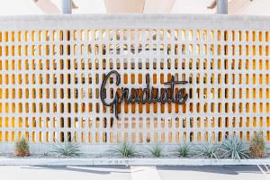 a facade of a building with a sign that reads excellence at Graduate by Hilton Tempe in Tempe