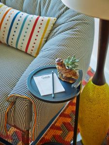 a blue plate with a letter on a table next to a couch at Graduate by Hilton Tempe in Tempe