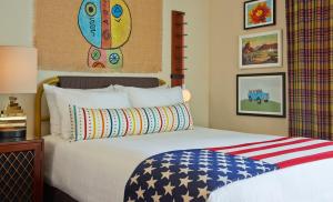 a bedroom with a bed with an american flag on it at Graduate by Hilton Tempe in Tempe