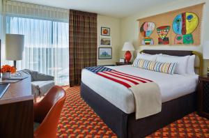 a hotel room with a large bed and a desk at Graduate by Hilton Tempe in Tempe