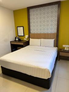 Postel nebo postele na pokoji v ubytování South of The Clouds HOTEL KL Sentral 吉隆坡彩云之南酒店-中央车站店