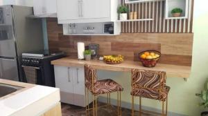 a kitchen with a counter with a bowl of fruit on it at AGC Penthouse - Ground Floor Apartment in Zamboanga