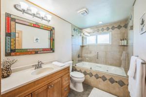 a bathroom with a tub and a toilet and a sink at Bright & Cozy House Centennial Littleton 4 Bed 3 Bath in Centennial +22 photos