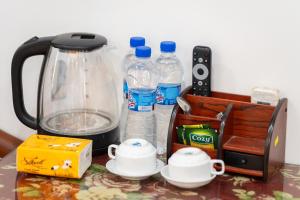 a counter with a blender and bottles of water at TamCoc Golden Shine Homestay in Ninh Binh