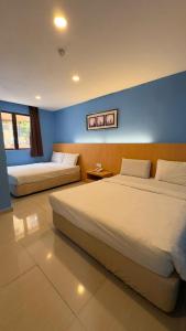 Postel nebo postele na pokoji v ubytování South of The Clouds HOTEL KL Sentral 吉隆坡彩云之南酒店-中央车站店