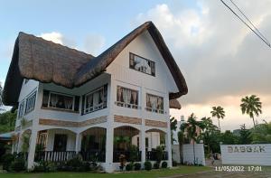 a house with a thatched roof at Baggak Hotel & Restaurant by SMS Hospitality in Sanchez-Mira
