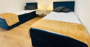 two beds in a room with two beds sidx sidx sidx at StayWorkHerzo in Herzogenaurach