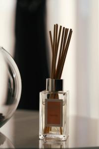 a glass bottle with sticks in it on a table at Villa Mila 1 in Vukovar