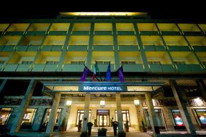 a hotel with purple flags on the front of it at Mercure Catania Excelsior in Catania