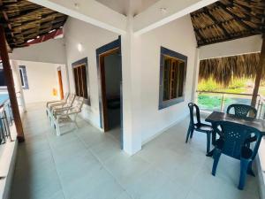 a room with a table and chairs on a patio at Cabaña Sol y Mar Coveñas in Coveñas