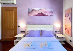 a bedroom with a white bed with towels on it at Sun Nest Apartment - terrace & garage in Fiumicino