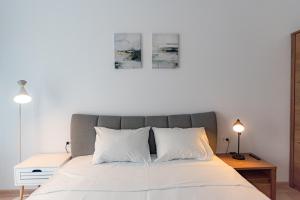 a bedroom with a large bed with white pillows at Apart B&V 706 Coresi - Balcony & Free Parking in Braşov