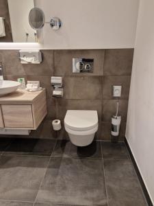 a bathroom with a toilet and a sink at Ferienappartment Marianne in Schliersee +5 photos