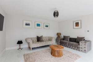 a living room with two couches and a coffee table at The Country Toll Bar Farmhouse in Grimsby