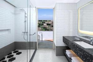 a bathroom with a shower and a sink at Aloft Bali Seminyak in Seminyak