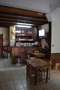 a dining room with a table and a kitchen at Argo Hotel in Athens