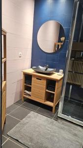 a bathroom with a sink and a mirror at Maison de ville in Louhans +1 photo