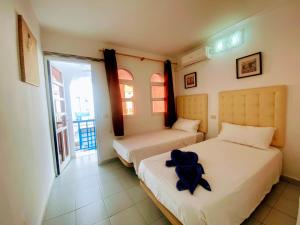Voodi või voodid majutusasutuse Playmar Pool by Wave Properties toas