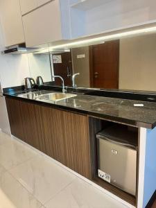 a kitchen with a sink and a counter top at Panbil Residence Apartment Batam in Kangboi