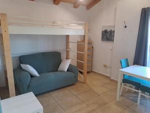 a living room with a couch and a bunk bed at Caseta del Riu in Deltebre
