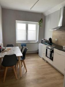 a kitchen with a table and a table and chairs at Ferienwohnung in Bad Wildungen, Erdgeschoß in Bad Wildungen