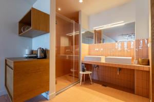 a kitchen with two sinks and a glass door at Amaze Place with a sea view by Salt Apartments in Volos