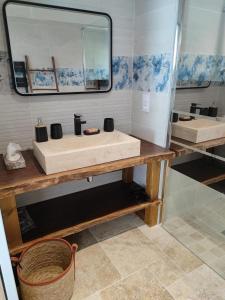 a bathroom with a sink and a mirror at Golf Open Sport Houses in Saint-Fort +39 photos