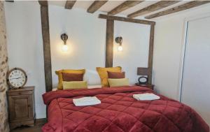 a bedroom with a large bed with a red blanket at Golf Open Sport Houses in Saint-Fort