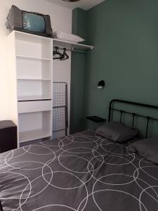 a bedroom with a bed and a dresser with a tv on it at Studio Cosy in Sainte-Marie-la-Mer