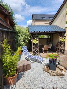 a patio with two lawn chairs and plants at Ferienwohnung Gruner - Cadolzburg - in Cadolzburg