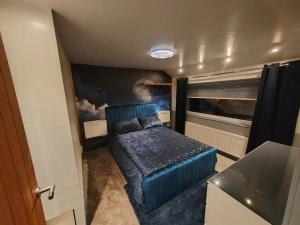 a bedroom with a blue bed in a room at Cozy Blackpool Retreat with 3 Bedrooms in Blackpool