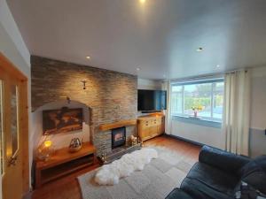 a living room with a fireplace and a tv at Cozy Blackpool Retreat with 3 Bedrooms in Blackpool