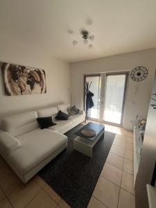 a living room with a white couch and a table at Casa da Matti in Gravedona +13 photos