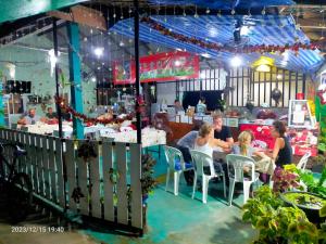 a group of people sitting at a table in a restaurant at Eco Bungalow in Ko Phayam